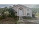 House exterior featuring a light-colored facade, landscaping, and a walkway at 310 Winter Green Dr, Winter Springs, FL 32708