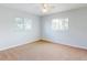 Well lit bedroom with neutral colored carpet and ceiling fan at 13729 Se 89Th Ave, Summerfield, FL 34491