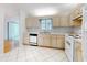 Bright eat-in kitchen with white appliances and light wood cabinets at 13729 Se 89Th Ave, Summerfield, FL 34491