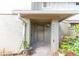 Condo entrance with a covered porch and blooming flowers at 4537 Ring Neck Rd # C, Orlando, FL 32808