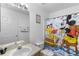 Bathroom with a shower/tub combination and a fun Mickey Mouse theme at 1010 Clear Creek Cir, Clermont, FL 34714