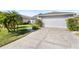 Home's exterior featuring a driveway and landscaping at 1010 Clear Creek Cir, Clermont, FL 34714