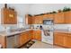 Well-equipped kitchen with wood cabinets and stainless steel appliances at 1010 Clear Creek Cir, Clermont, FL 34714