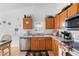 Well-equipped kitchen with wood cabinets and stainless steel appliances at 1010 Clear Creek Cir, Clermont, FL 34714