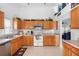 Well-equipped kitchen with wood cabinets and stainless steel appliances at 1010 Clear Creek Cir, Clermont, FL 34714