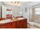 Bathroom with double vanity, shower, and tile flooring at 8007 Acadia Estates Ct, Kissimmee, FL 34747