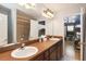 A bathroom is displayed that includes double sinks and a tile shower stall at 8007 Acadia Estates Ct, Kissimmee, FL 34747
