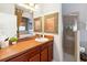 Well-lit bathroom featuring a walk-in shower, vanity with sink, and modern fixtures at 8007 Acadia Estates Ct, Kissimmee, FL 34747