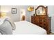 Bedroom with a king-size bed and wood dresser at 8007 Acadia Estates Ct, Kissimmee, FL 34747