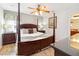 Bedroom with a king-size bed and wood furniture at 8007 Acadia Estates Ct, Kissimmee, FL 34747