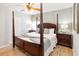 King-size bed in a spacious bedroom with wood furniture at 8007 Acadia Estates Ct, Kissimmee, FL 34747