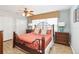 Stylish bedroom featuring a decorative headboard, warm colors and wood-style flooring at 8007 Acadia Estates Ct, Kissimmee, FL 34747