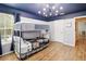 A shared bedroom includes bunk beds, a blue painted ceiling and natural light at 8007 Acadia Estates Ct, Kissimmee, FL 34747