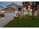 Two-story house with a large lawn and attached garage at 8007 Acadia Estates Ct, Kissimmee, FL 34747