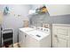Well-equipped laundry room with modern appliances and ample shelving for storage at 8007 Acadia Estates Ct, Kissimmee, FL 34747