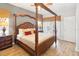 Spacious main bedroom with a four-poster bed and wood floors at 8007 Acadia Estates Ct, Kissimmee, FL 34747
