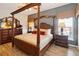 Main bedroom with large four poster bed and wood furniture at 8007 Acadia Estates Ct, Kissimmee, FL 34747