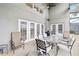 Covered outdoor patio featuring a dining area, grill, and neutral color palette at 8007 Acadia Estates Ct, Kissimmee, FL 34747