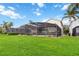 Screened pool and spa area with lush lawn at 8007 Acadia Estates Ct, Kissimmee, FL 34747