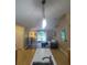 Open kitchen with island, stainless steel appliances, and hardwood floors at 15900 Sw 19Th Avenue Rd, Ocala, FL 34473