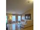 Bright living room with a sectional sofa, large windows, and light wood flooring at 15900 Sw 19Th Avenue Rd, Ocala, FL 34473