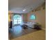 Living room with vaulted ceiling, large window, sectional sofa and wood floors at 15900 Sw 19Th Avenue Rd, Ocala, FL 34473
