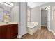 Main bathroom with soaking tub, double vanity and walk-in closet at 4014 Sunburst View Cir, Kissimmee, FL 34746