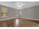 Spacious bedroom with wood-look tile flooring and large window at 4014 Sunburst View Cir, Kissimmee, FL 34746