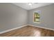Well-lit bedroom with wood-look tile flooring and window at 4014 Sunburst View Cir, Kissimmee, FL 34746