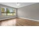 Bedroom with large window, wood-look tile, and ceiling fan at 4014 Sunburst View Cir, Kissimmee, FL 34746