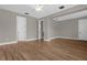 Spacious bedroom with wood-look tile flooring and multiple doors at 4014 Sunburst View Cir, Kissimmee, FL 34746