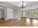 Bright dining area, hardwood floors, chandelier, and neutral walls at 4014 Sunburst View Cir, Kissimmee, FL 34746
