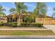 Single-story house with palm trees and landscaped yard at 4014 Sunburst View Cir, Kissimmee, FL 34746