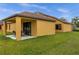 House exterior with covered patio and yard at 4014 Sunburst View Cir, Kissimmee, FL 34746