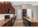 Modern kitchen with dark wood cabinets and black appliances at 4014 Sunburst View Cir, Kissimmee, FL 34746
