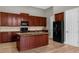 Kitchen with dark wood cabinets and granite countertops at 4014 Sunburst View Cir, Kissimmee, FL 34746
