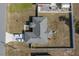 An aerial view shows the home's roof, driveway with two cars, and a white-fenced backyard at 12854 Sw 77Th Cir, Ocala, FL 34473