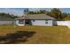 A spacious backyard with a blue fountain, a screened lanai, and white vinyl fencing at 12854 Sw 77Th Cir, Ocala, FL 34473