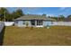A spacious backyard with a blue fountain, a screened lanai, and white vinyl fencing at 12854 Sw 77Th Cir, Ocala, FL 34473