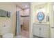 Well-lit bathroom featuring a tiled shower with glass door and a vanity with granite countertop at 12854 Sw 77Th Cir, Ocala, FL 34473
