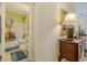 Bathroom with a shower-tub combo, a white toilet, light tile floors, and a vanity with storage at 12854 Sw 77Th Cir, Ocala, FL 34473