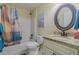 Bathroom featuring a shower-tub combination with blue shower curtain and a vanity with countertop space at 12854 Sw 77Th Cir, Ocala, FL 34473