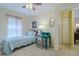 Sunlit bedroom with carpet, small desk, and easy access to a full bathroom and closet at 12854 Sw 77Th Cir, Ocala, FL 34473