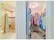 View of a walk-in closet with ample storage and organization, connected to a full bathroom with tiled shower at 12854 Sw 77Th Cir, Ocala, FL 34473