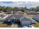 Well-maintained single-Gathering home with American flag, two-car garage and manicured lawn at 12854 Sw 77Th Cir, Ocala, FL 34473