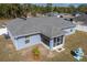 Aerial view of backyard featuring screened patio, fountain, and white vinyl fence at 12854 Sw 77Th Cir, Ocala, FL 34473