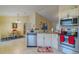 Open kitchen with stainless steel appliances and granite countertops, flowing into the dining area at 12854 Sw 77Th Cir, Ocala, FL 34473