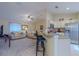 Open kitchen with counter seating, stainless steel appliances, and a view to the living area at 12854 Sw 77Th Cir, Ocala, FL 34473