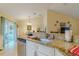 Spacious kitchen featuring granite countertops and seamlessly connects to the adjacent dining and living spaces at 12854 Sw 77Th Cir, Ocala, FL 34473