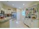 Bright kitchen featuring stainless steel appliances, granite countertops, and a decorative hutch at 12854 Sw 77Th Cir, Ocala, FL 34473